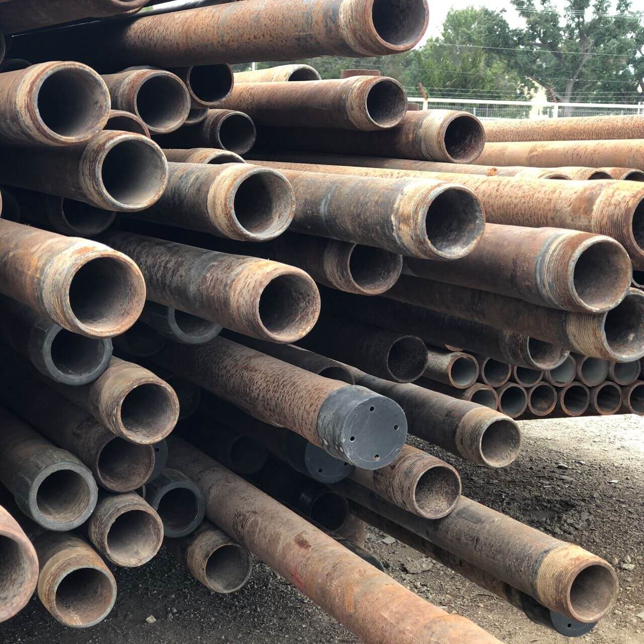 A pile of pipes sitting on top of the ground.